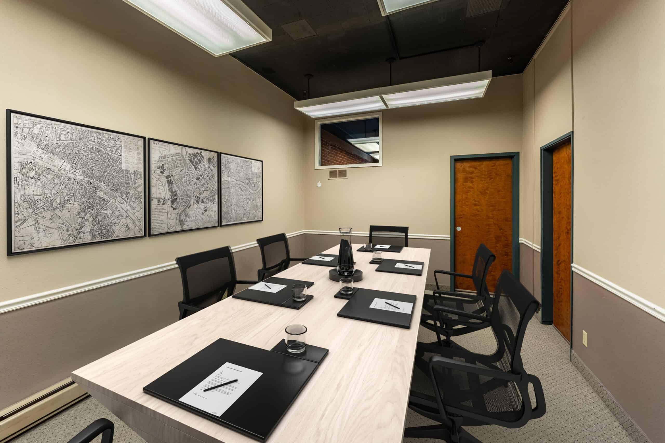 Conference room with framed maps inside one of the historic buildings